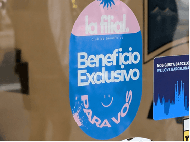 Sticker Beneficio Exclusivo de La Filial en la vidriera de un local
