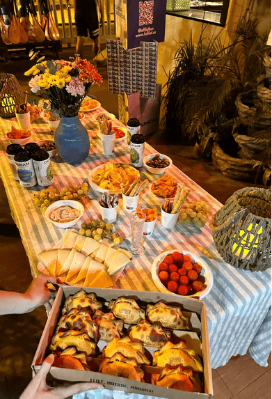 Mesa larga con empanadas y picada argentina en un evento de La Filial
